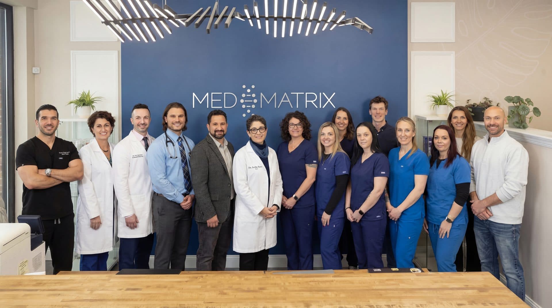The Med Matrix providers and staff together at the front desk of the South Portland clinic.